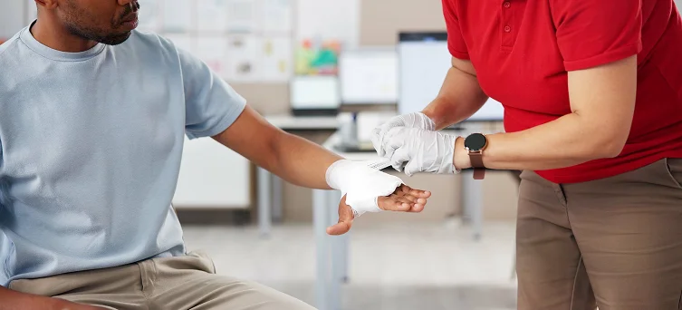 Medical professional treating a burn injury, with legal support for workers seeking compensation in California.